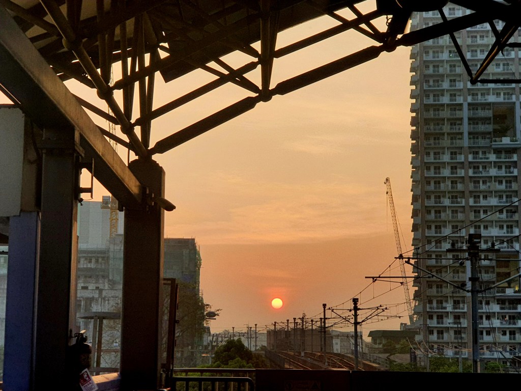 view of a sunrise from a train station in Metro Manila